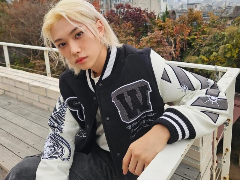 Stray Kids Felix wearing varsity jacket